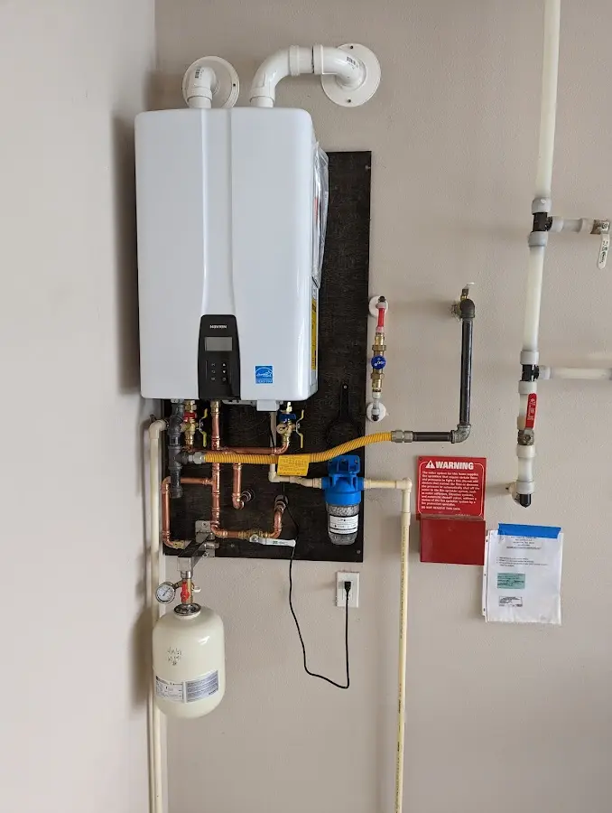 Professional plumber installing copper piping in a St. Albans home